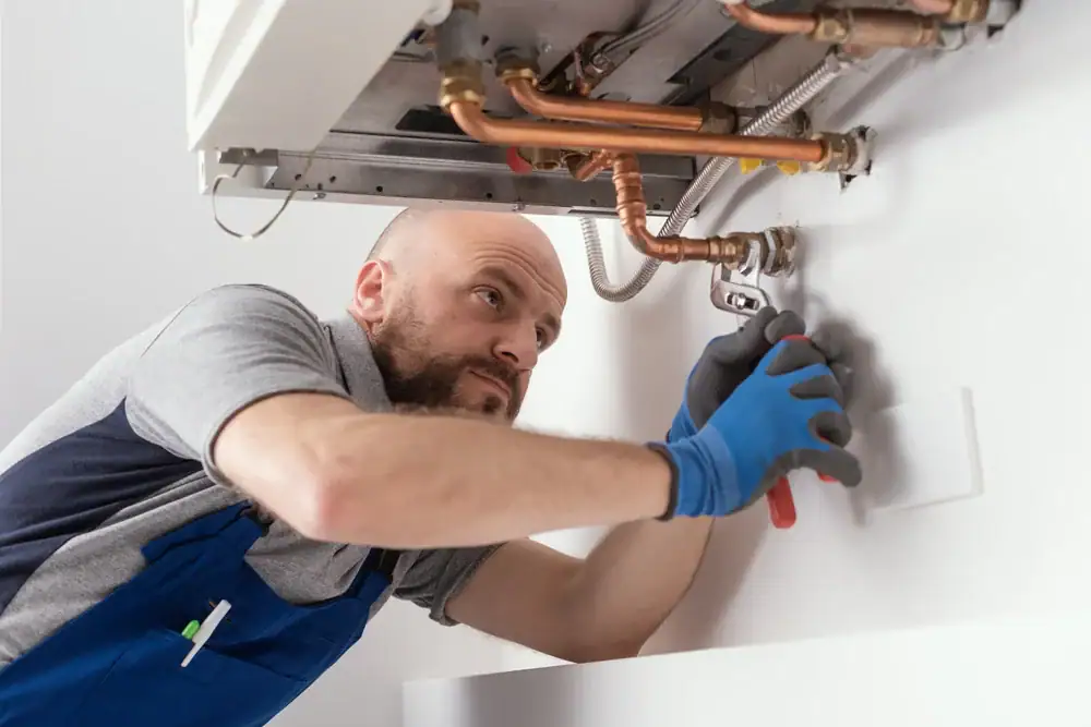Expert plumber repairing a water heater in Bergen County, NJ, with Super Plumbing Heating offering reliable and fast solutions to water heating issues in local homes