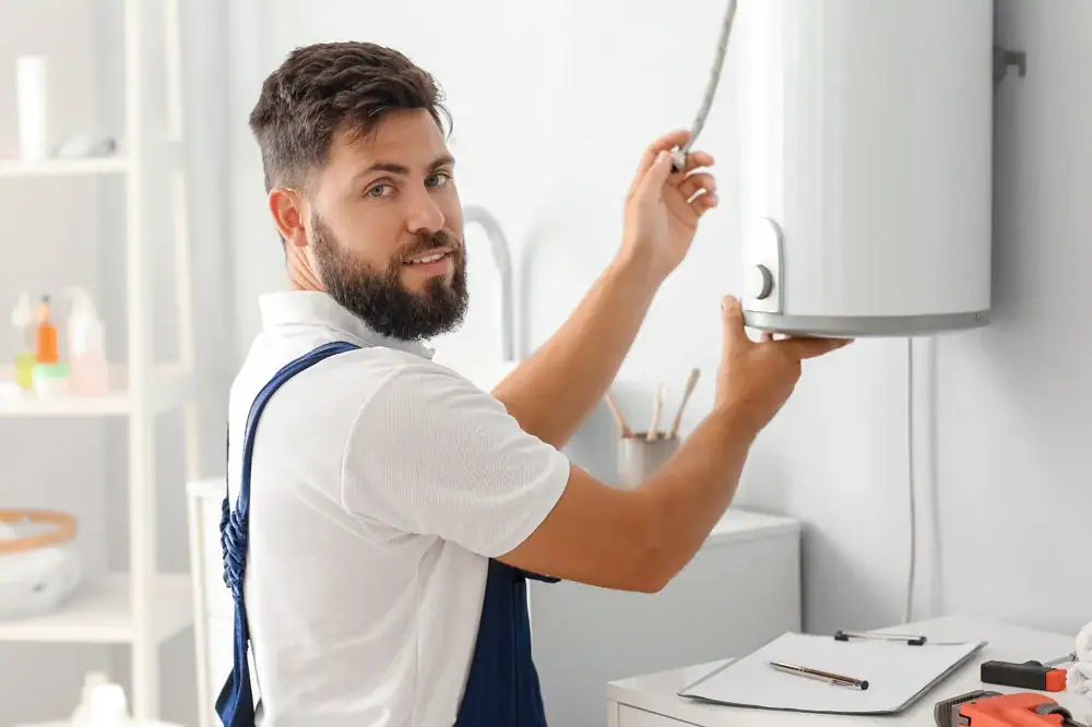 Experienced plumber repairing a water heater in a home in Bergen County, NJ, ensuring reliable hot water for the family