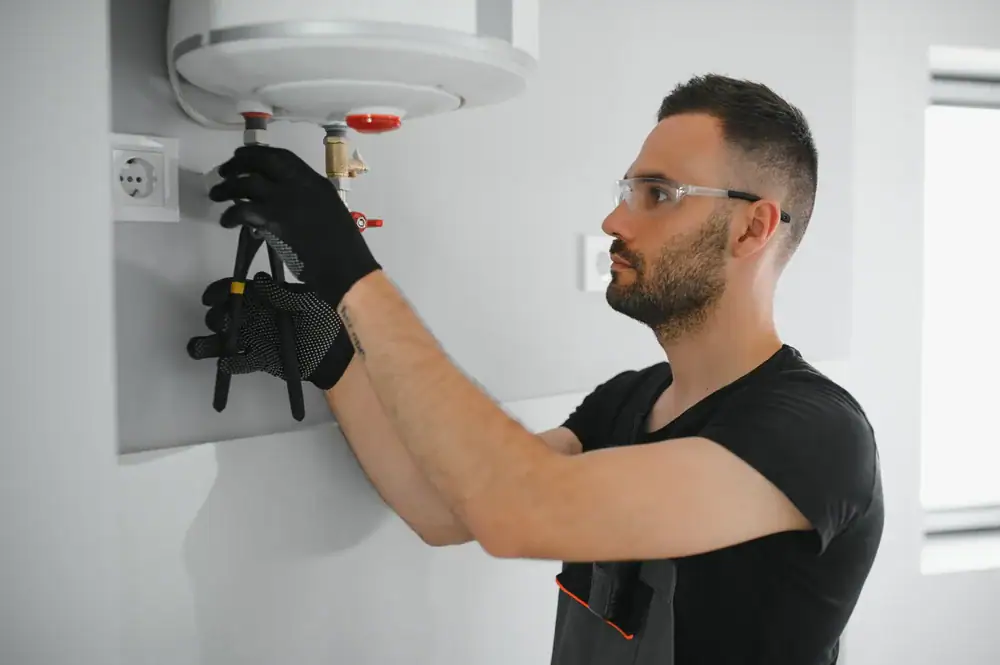 Plumber fixing a water heater in Bergen County, NJ, ensuring efficient heating for a local home with professional plumbing services from Super Plumbing Heating